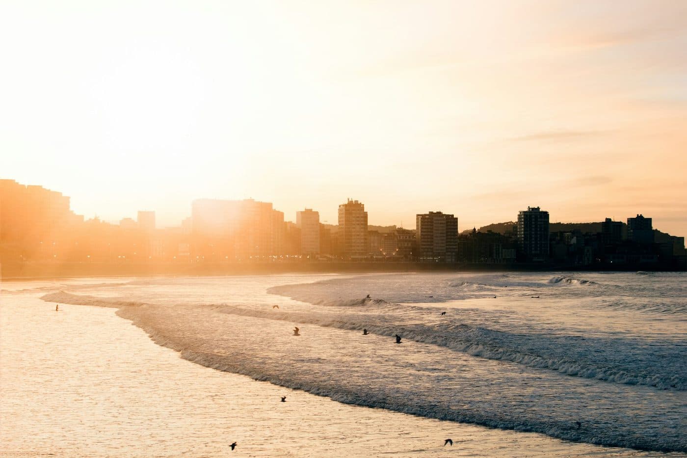 San Lorenzo beach and the Gijón skyline at sunset